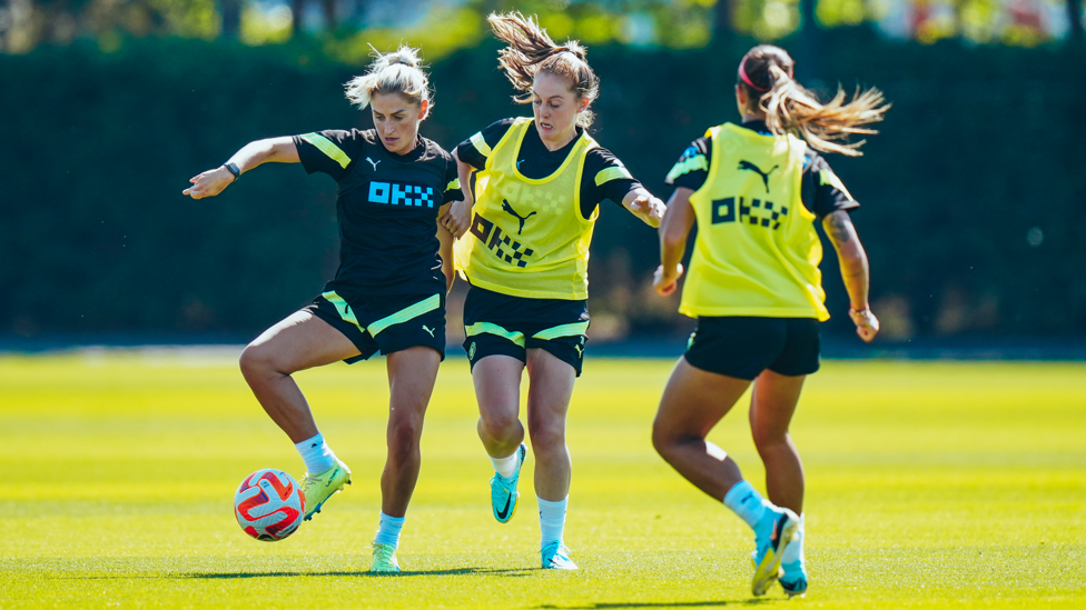 BATTLE OF THE BALL WINNERS : Laura Coombs and Keira Walsh tussle for possession