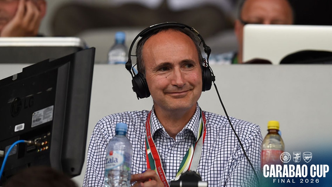 Person wearing headphones and using a monitor at the Carabao Cup Final 2026. Logos of Leicester City and Arsenal in the corner.