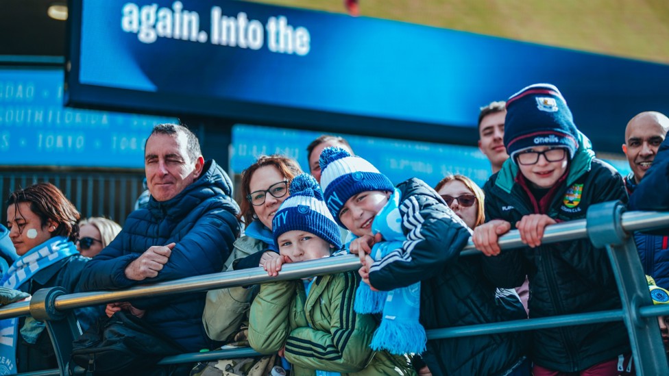 AWAITING THEIR HEROES : City fans line up outside the Etihad ahead of arrivals