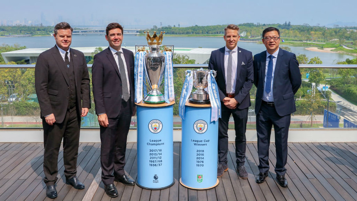 ndy Burnham, Mayor of Greater Manchester (second left) is pictured in Shenzhen with City Football Group executives and the Premier League and Carabao Cup trophies that were won by Manchester City last season. 