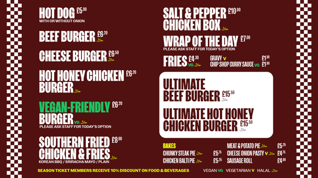 Menu board with food options including hot dogs, burgers, fries, and pies. Different dietary options are marked as vegan, vegetarian, and halal.