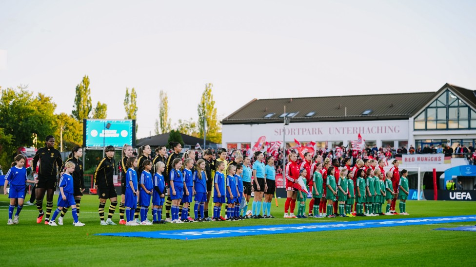 READY TO GO  : The teams take to the pitch. 