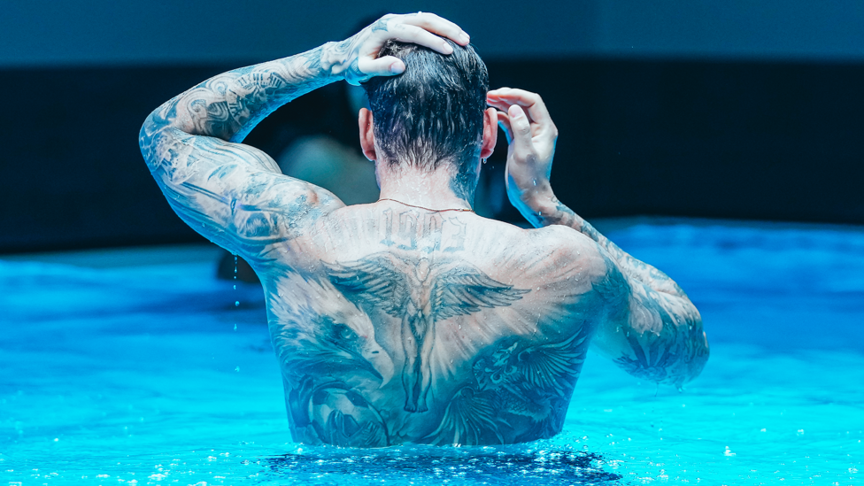 SAFE HANDS : Ederson emerges from the water in front of our camera