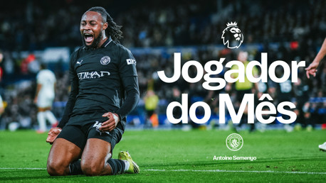 A football player in a Manchester City kit kneeling and celebrating on the field with text 'Jogador do Mês' and 'Antoine Semenyo'. Premier League logo is visible.