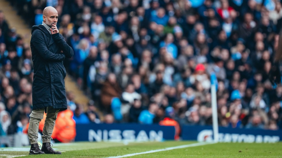 PONDERING : Pep watching on from the technical area