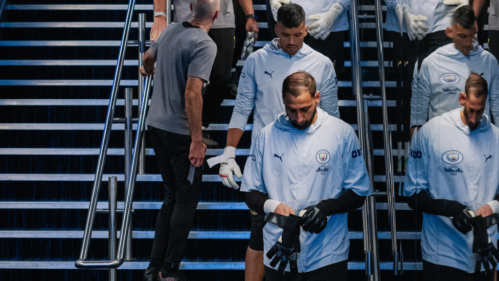 GOALKEEPER'S UNION : Emerging for the pre-match warm up.
