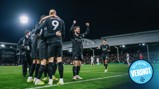 Manchester City players celebrate a goal during a match at Fulham's stadium. Erling Haaland is prominently visible with the number 9 on his jersey.