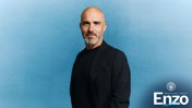 Man with a black jacket against a blue background. Welcome back Enzo text with Manchester City logo in the corner.