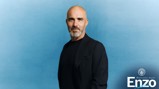 Man with a black jacket against a blue background. Welcome back Enzo text with Manchester City logo in the corner.