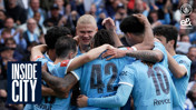 Players from the Manchester City team in a group huddle wearing light blue jerseys with numbers 42 and 10 visible during a football match.