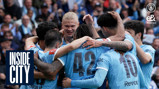 Players from the Manchester City team in a group huddle wearing light blue jerseys with numbers 42 and 10 visible during a football match.