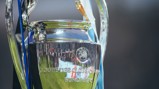 Close-up of the UEFA Champions League trophy with black and blue ribbons attached.