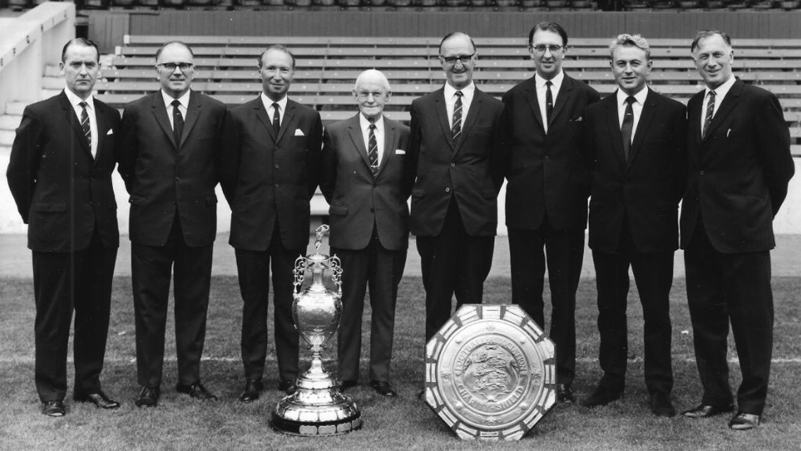 TRUE BLUE: Eric Alexander is pictured second right next to Joe Mercer and City's directors following our 1968 league title and Charity Shield triumphs