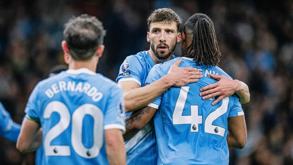 HUG IT OUT : Dias and Semenyo share a moment