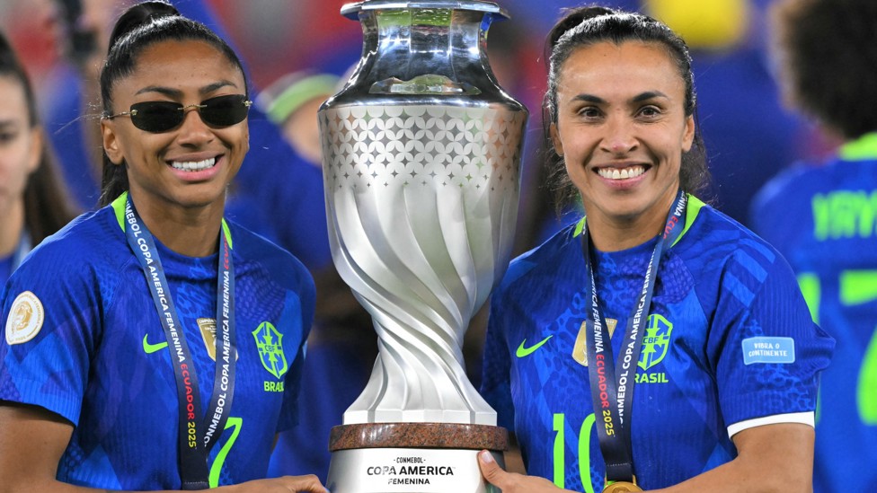 LIFTING THE TITLE: Kerolin and Marta hold the trophy 