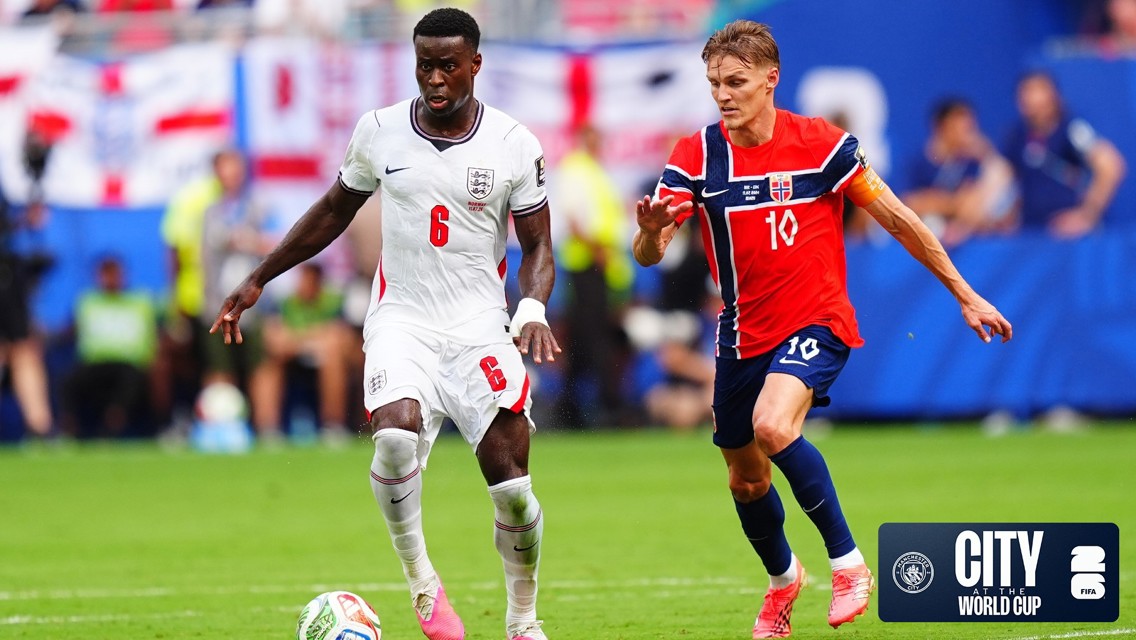 A soccer match between teams from England and Norway. Players in action wearing national jerseys on the field. The City World Cup logo appears in the corner.