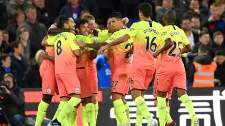 GROUP HUG: The players share the love after the spectacular second goal.