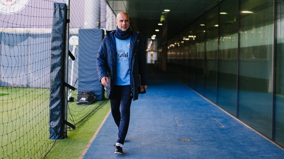 READY TO WORK  : Pep Guardiola heads onto the training pitch. 