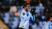 A soccer player wearing Manchester City's light blue kit and gloves clapping during a Women's Super League match.