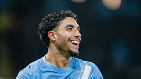 A person wearing a light blue soccer jersey with white accents, showcasing the Puma logo, representing Manchester City.