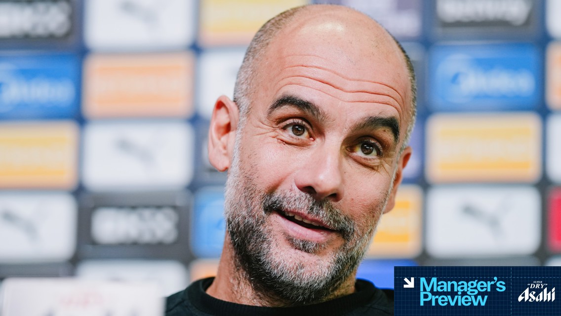 Image of a person with a blurred face at a press conference. Logotypes of sponsors are visible in the background, and text in the lower corner reads 'Manager's Preview' with 'Super Dry Asahi'.