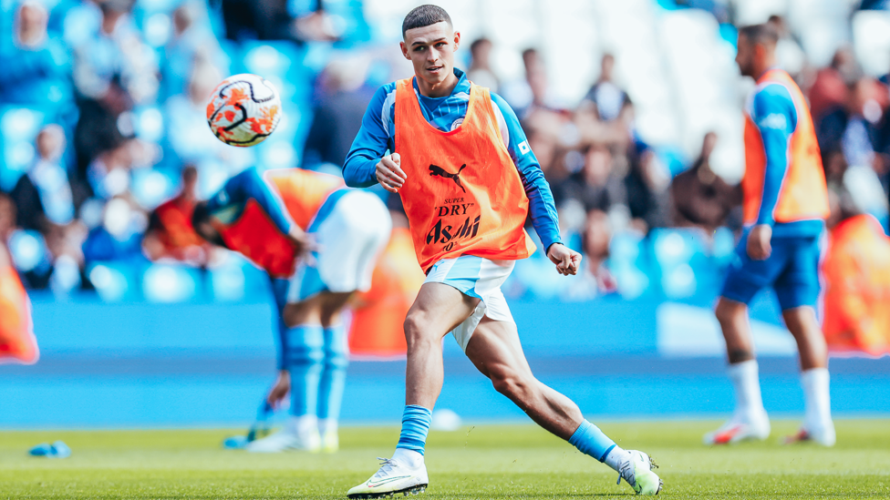 PHIL-ING GOOD : Foden gets in the mood during the pre-match warm up.