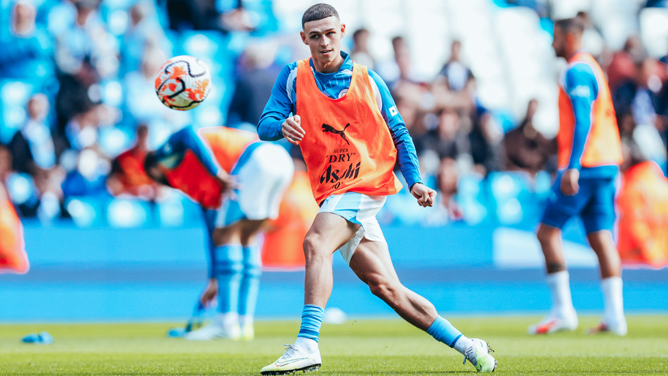 PHIL-ING GOOD : Foden gets in the mood during the pre-match warm up.