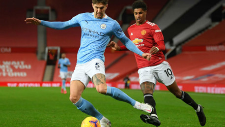 CENTRE OF ATTENTION: John Stones snuffs out the threat of Marcus Rashford