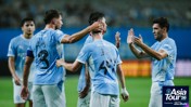 Manchester City players celebrating a goal during the Asia Tour 2026, presented by Abu Dhabi. Players wear light blue kits with Japanese characters. The event logo is visible.