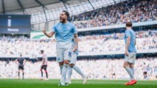 Manchester City player celebrating a goal during a football match at Etihad Stadium.