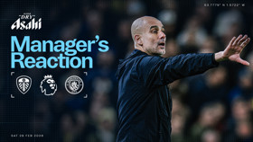 Blurred image of a football manager gesturing with 'Manager's Reaction' text. Logos of Leeds United, Premier League, Manchester City, coordinates, and date 'Sat 28 Feb 2026'.
