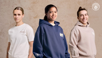Three individuals modeling Manchester City branded casual wear, featuring a t-shirt and two hoodies.