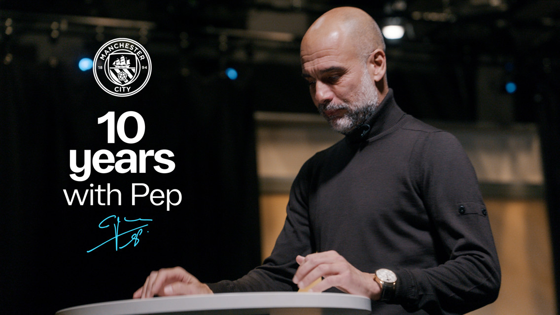 A person at a podium with the Manchester City logo and text '10 years with Pep'