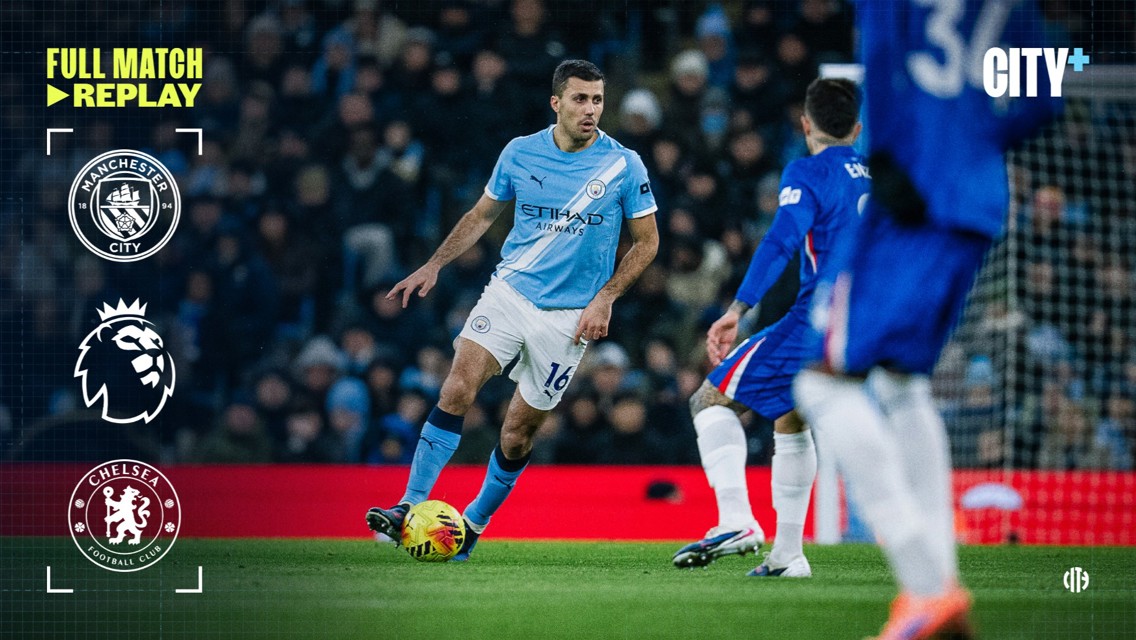 A Manchester City player in light blue jersey with '16' on his shorts controls the ball against a Chelsea player in dark blue kit. The image features Manchester City and Premier League logos, indicating a match replay.