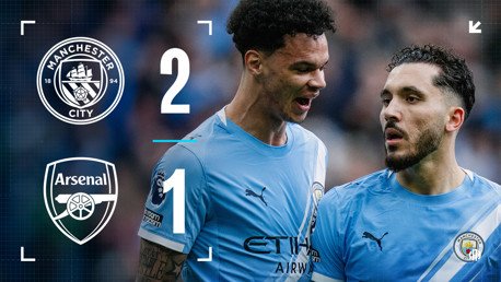 Graphic showing Manchester City 2-1 victory over Arsenal. Manchester City crest and Arsenal crest included. Two unidentified players in Manchester City kit partially visible.