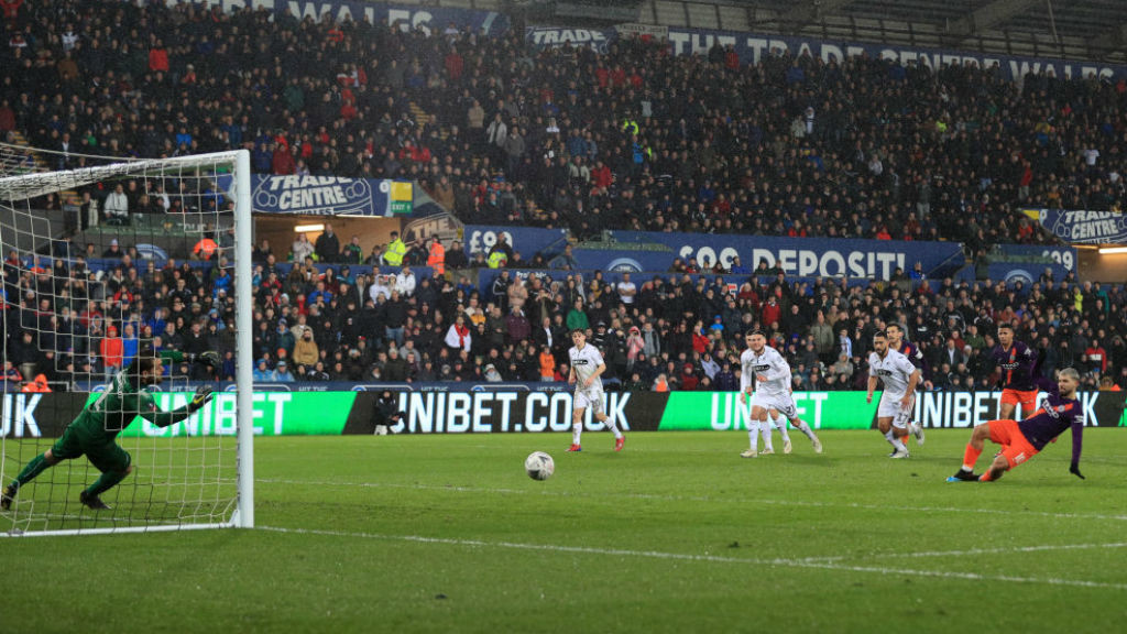 HIGH DRAMA: Kun's penalty goes in off the Swansea keeper's foot