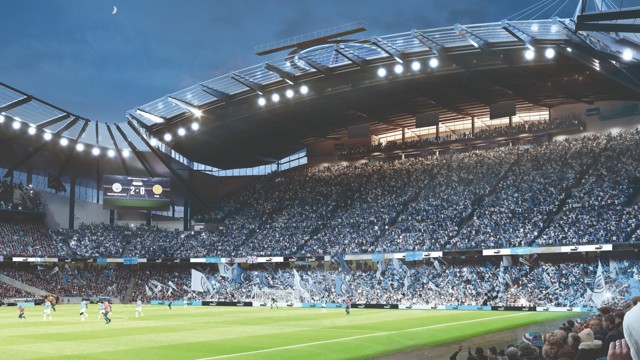 A football match at a stadium during the night with a scoreboard showing Manchester City 2-0 another team. The stadium is packed with spectators under the illuminated floodlights and a crescent moon in the sky.