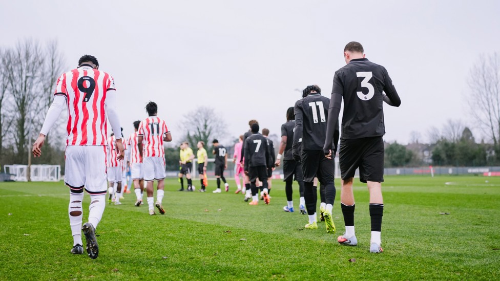 READY TO GO  : Stoke and City make their way out onto the pitch.