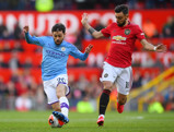 Bernardo Silva takes on Bruno Fernandes.