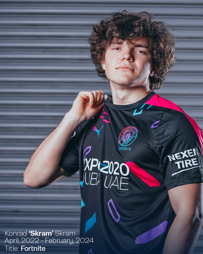 Person in a Manchester City esports jersey holding the collar of the shirt. Text indicates 'Konrad ‘Skram’ Skram, April, 2022 - February, 2024, Title: Fortnite.'