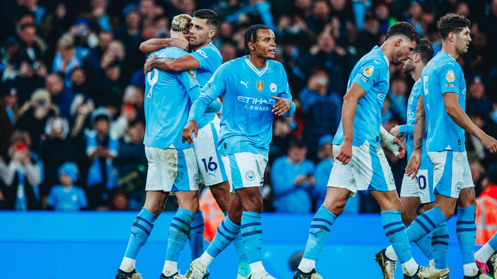 HAALAND HUG : Our number nine celebrates with Rodrigo.