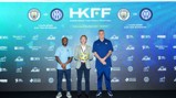 Football press conference announcing the Hong Kong Football Festival with Manchester City vs Inter Milan at Kai Tak Stadium. Three individuals, one holding a ball, stand in front of a backdrop featuring logos and details of the event.