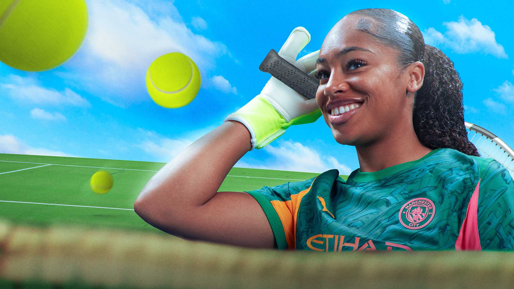 A person in a Manchester City jersey holding a tennis racquet with tennis balls in the air, set against a sky and field background.