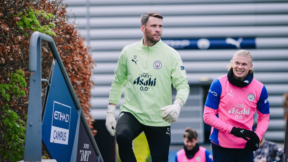 HEADING OUT : Marcus Bettinelli and Erling Haaland make their way out to the training pitches. 
