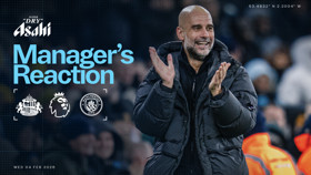 A manager clapping at a football match between Sunderland AFC and Manchester City, featuring the Premier League logo, sponsored by Asahi Super Dry.
