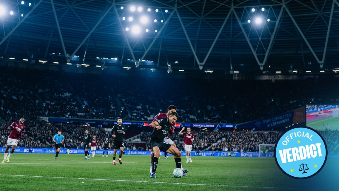 Soccer players in action during a nighttime match in a stadium, with an 'Official Verdict' logo in the foreground.