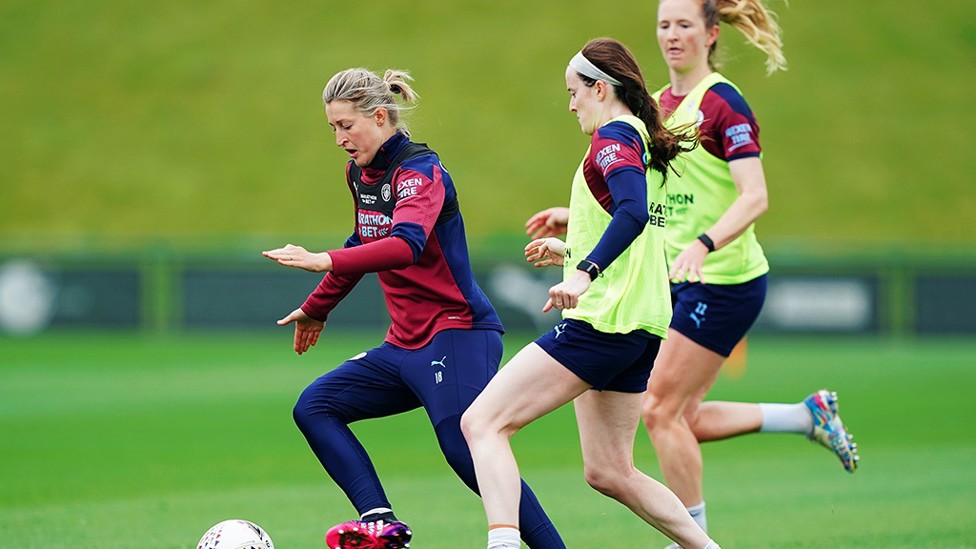 MY BALL : White shields the ball from two opponents as the session intensity rises.