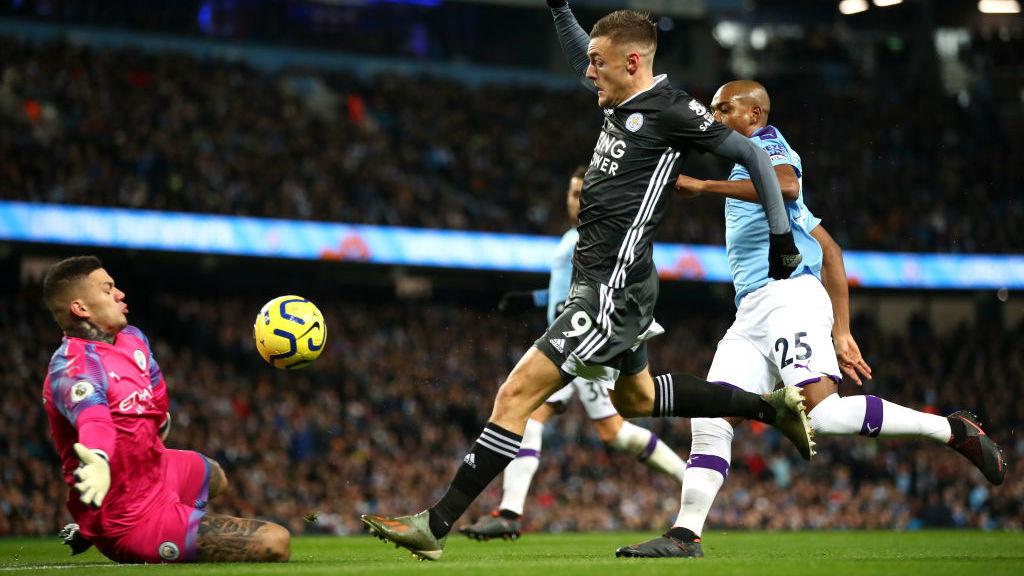 OPENER: Vardy clips the ball over Ederson to give Leicester the lead.