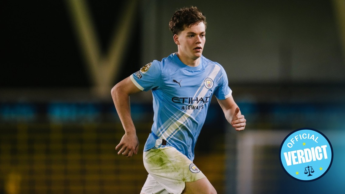 A Manchester City football player in action wearing a blue jersey with Etihad Airways sponsorship, running on the field. 'Official Verdict' badge is displayed.