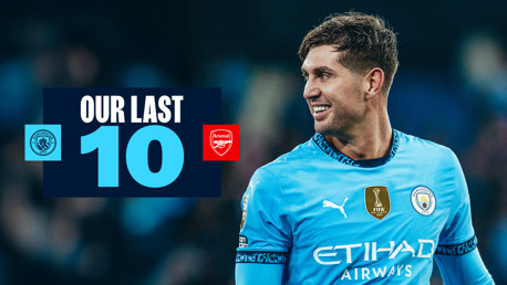 Blurred photo with Manchester City player, text 'Our Last 10,' and logos of Manchester City and Arsenal visible.